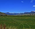 High mountain cattle pasture in front of Absaroka Mountain Range under summer cirrus and lenticular clouds near Dubois Wyoming Royalty Free Stock Photo