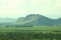 A high mountain in the endless steppe overgrown with grass and rare bushes