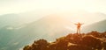 High Mountain hiker with backpack tiny figurine stands on mountain peak