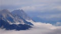High mountain peaks rising from the fog in the valley