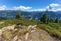 High mountain scenery with blue cloudy sky and stones in the foreground. Austria, Tirol, Zillertal, Zillertal High Alpine Road,