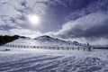 High mountain snowy landscape with sun rays and sky with clouds. La Morcuera Royalty Free Stock Photo