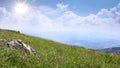 High mountain valley with green grass and blue sky