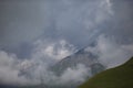 High mountains in low clouds. Mountain landscape Royalty Free Stock Photo