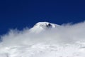 High mountains off-piste slopes for freeride with traces of skis and snowboards, sunny winter day, Caucasus Mountains, Elbrus Royalty Free Stock Photo