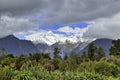 High mountains with snow on top in the winter, beautiful skies and clouds. The grass is yellow in Mount Cook Rd Royalty Free Stock Photo