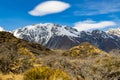 High mountains with snow on top in the winter, beautiful skies and clouds. The grass is yellow in Mount Cook Rd Royalty Free Stock Photo