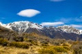 High mountains with snow on top in the winter, beautiful skies and clouds. The grass is yellow in Mount Cook Rd Royalty Free Stock Photo