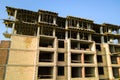 High multi storey residential apartment building under construction. Concrete and brick framing of high rise housing. Real estate Royalty Free Stock Photo