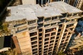 High multi storey residential apartment building under construction. Concrete and brick framing of high rise housing. Real estate Royalty Free Stock Photo