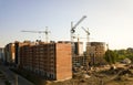 High multi storey residential apartment buildings under construction. Concrete and brick framing of high rise housing. Real estate Royalty Free Stock Photo