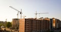 High multi storey residential apartment buildings under construction. Concrete and brick framing of high rise housing. Real estate Royalty Free Stock Photo