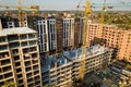 High multi storey residential apartment buildings under construction. Concrete and brick framing of high rise housing. Real estate Royalty Free Stock Photo