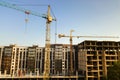 High multi storey residential apartment buildings under construction. Concrete and brick framing of high rise housing. Real estate Royalty Free Stock Photo