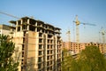 High multi storey residential apartment buildings under construction. Concrete and brick framing of high rise housing. Real estate Royalty Free Stock Photo