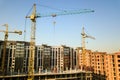 High multi storey residential apartment buildings under construction. Concrete and brick framing of high rise housing. Real estate