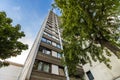 High multistoried apartment building with trees against blue sky Royalty Free Stock Photo