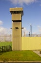 A high observation tower at the corner of a modern prison at Magilligan point in County Londonderry in Northern Ireland Royalty Free Stock Photo