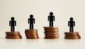 High paying jobs. Social stratification concept. Miniature people on stacks of coins Royalty Free Stock Photo