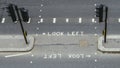 High perspective view of empty pedestrian crossing in the City of London. Iconic look left and look right signs painted Royalty Free Stock Photo