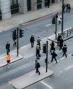 High perspective view of officer worker pedestrians in the City of London crossing the street