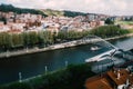 High perspective view of people crossing Zubizuri bridge in Bilbao, Spain - tilt shift selective focus effect