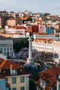 High perspective view of Rossio Square in Baixa district of Lisbon city, Portugal covered with violet Jacaranda leaves