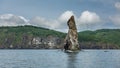 A high picturesque cliff rises above the water.