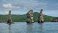 High picturesque rocks rise above the ocean.