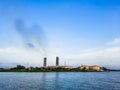 High pollution from power plant. Power plant on the coast. Ecology disaster concept. Royalty Free Stock Photo