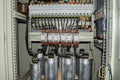 High-power capacitors installed in the electric box. Powerful electrical switches.