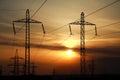 High power electric line towers at dramatic sunset Royalty Free Stock Photo