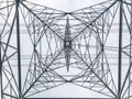 High power pylons and natural green with clear skies.