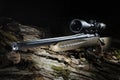 High powered optic on a hunting rifle in a dark forest Royalty Free Stock Photo