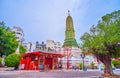 The high Prang of Wat Ratchaburana temple and a small chinese shrine in Bangkok, Thailand Royalty Free Stock Photo