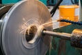 High-precision machining of the end face of the part on a circular grinding machine with an abrasive stone at high speeds Royalty Free Stock Photo