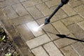 High-pressure washer watering concrete stones of garden line in country house