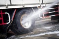 High Pressured Water Washing a Truck Wheels and Tires.