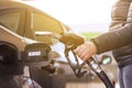 High prices of petrol and diesel fuel ath the petrol station, young woman refueling the car, economic crisis concept Royalty Free Stock Photo