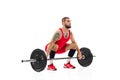Full length portrait of man in red sportswear exercising with a weight isolated on white background. Sport Royalty Free Stock Photo