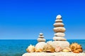 High pyramid of white stones and seashells. Rock Zen in the background of the summer sea. Royalty Free Stock Photo