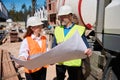 High qualified architect showing blueprint of construction site to foreman