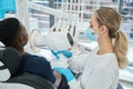 High-qualified woman stomatologist holding portable x-ray