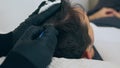 High quality close-up of a man laying on a couch during the esthetician hair treatment. Male tricopigmentation service. Royalty Free Stock Photo