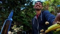 High quality close-up of a young blurred man on a bright summer nature background having fun and snacks with bottle of beer.