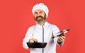 High quality frying pan. Bearded man cook white uniform. Homemade breakfast. Cooking like pro. Easy tasty meal prepared Royalty Free Stock Photo