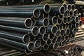 High quality Galvanized steel pipe or Aluminum and chrome stainless pipes in stack waiting for shipment in warehouse Royalty Free Stock Photo