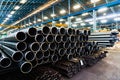 High quality Galvanized steel pipe or Aluminum and chrome stainless pipes in stack waiting for shipment in warehouse Royalty Free Stock Photo