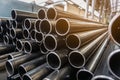 High quality Galvanized steel pipe or Aluminum and chrome stainless pipes in stack waiting for shipment in warehouse Royalty Free Stock Photo