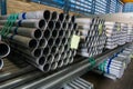 High quality Galvanized steel pipe or Aluminum and chrome stainless pipes in stack waiting for shipment  in warehouse Royalty Free Stock Photo